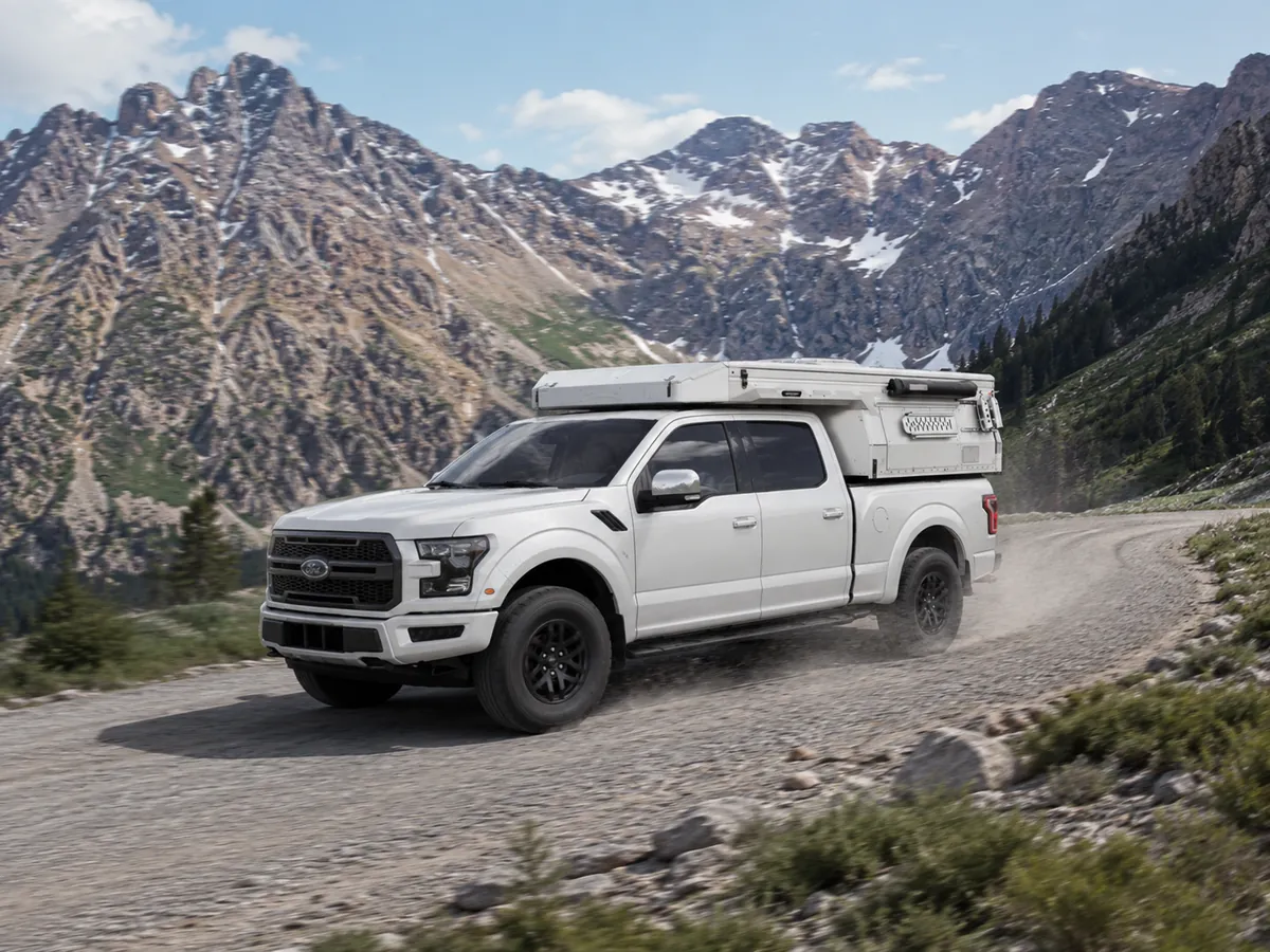 Truck camper driving on a mountain road